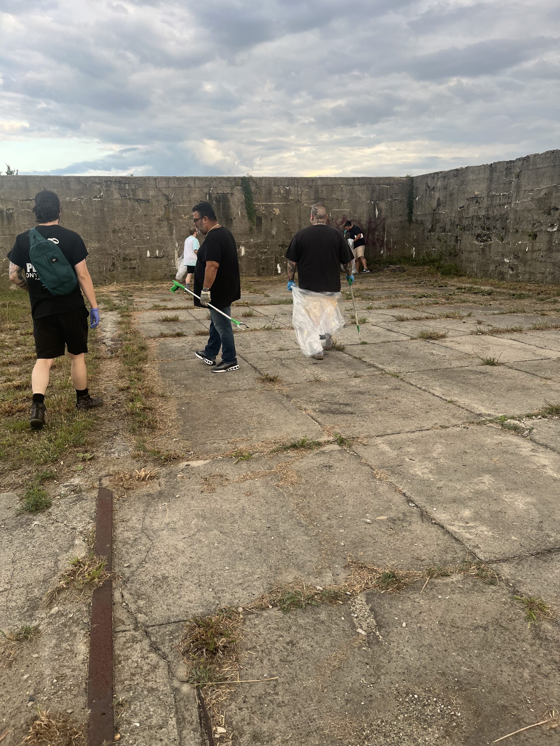 Cannabar dispensary beach cleanup event showing community members and staff working together