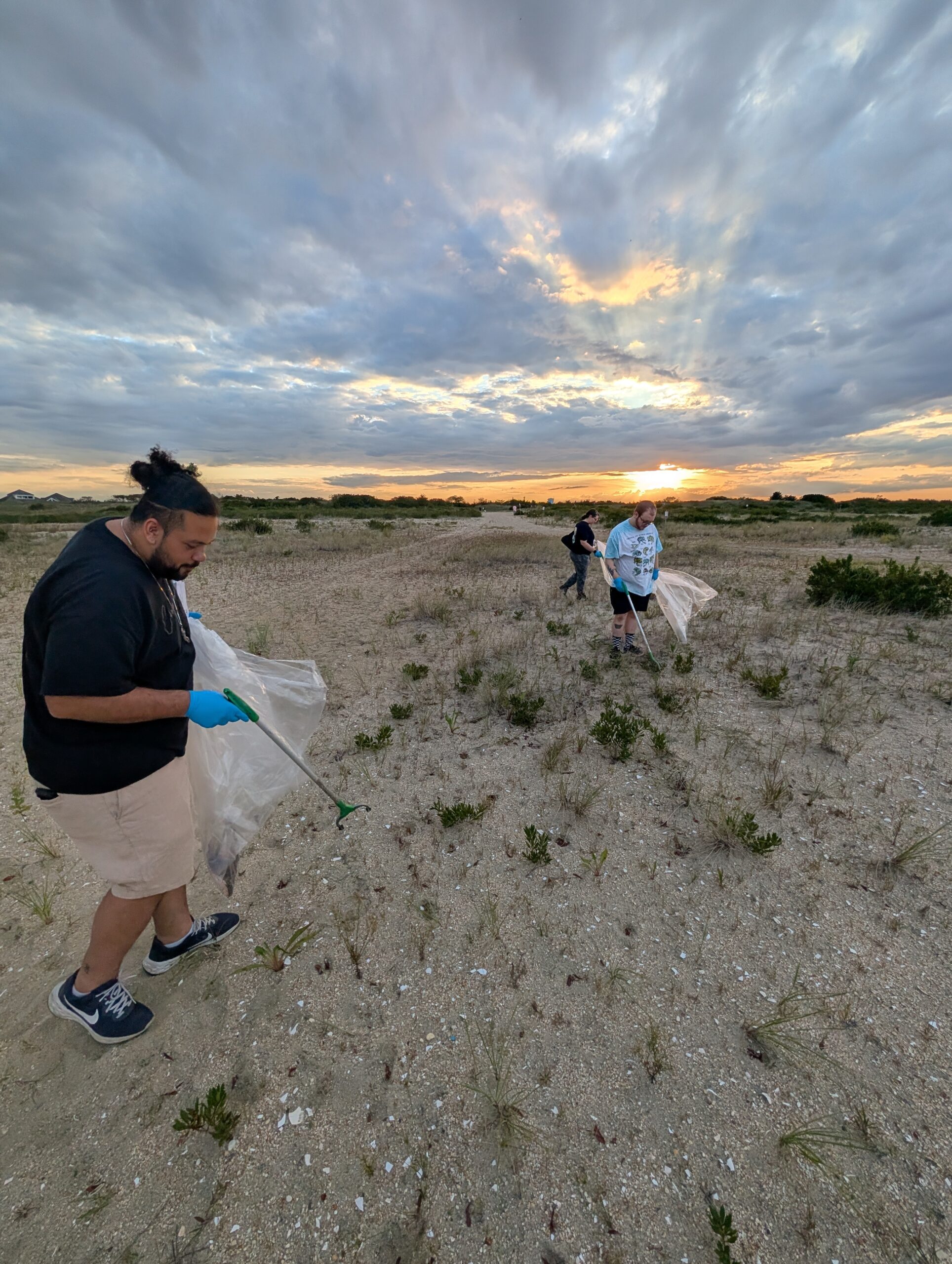 Community volunteers gathering at Sandy Hook Beach for environmental cleanup